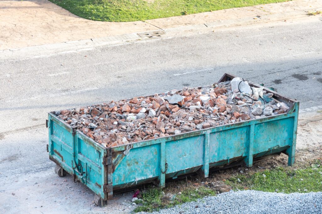 Garbage roro dumpter bin collects rubbish at construction site