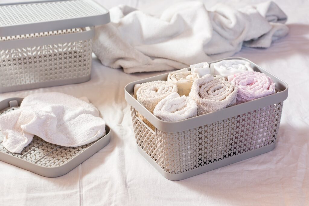 Neatly folded towels in a clothes drawer. Organization and order at home